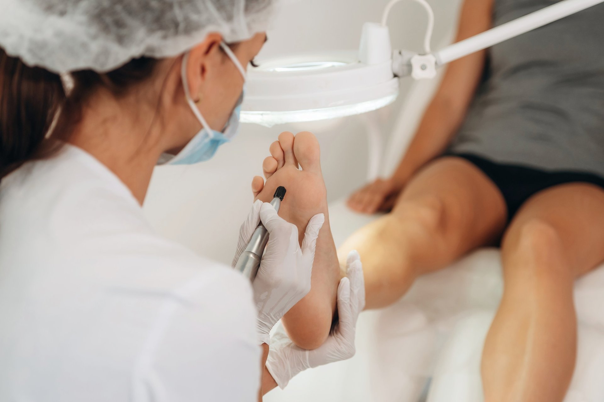 Dr. Priya Patel, Podiatrist examining patient foot