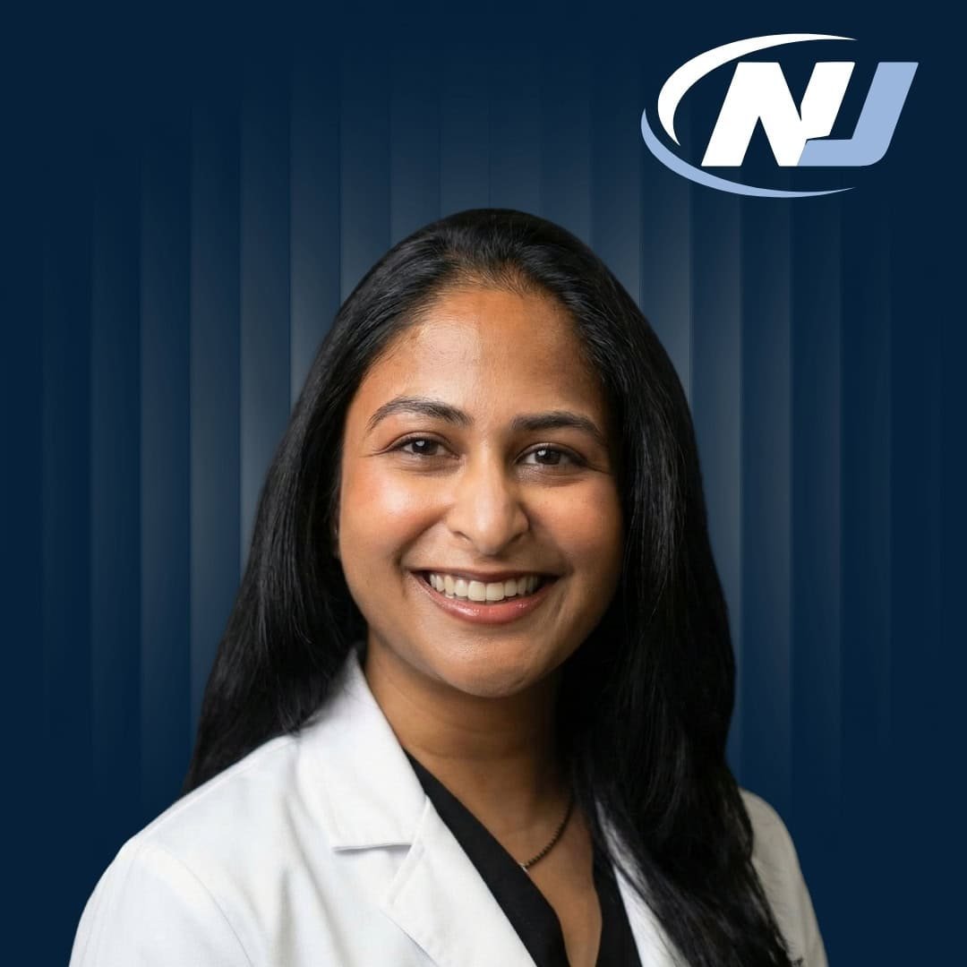 Professional headshot of Dr. Priya Patel, Podiatrist and Foot Ankle Specialist wearing a white coat with NJ logo